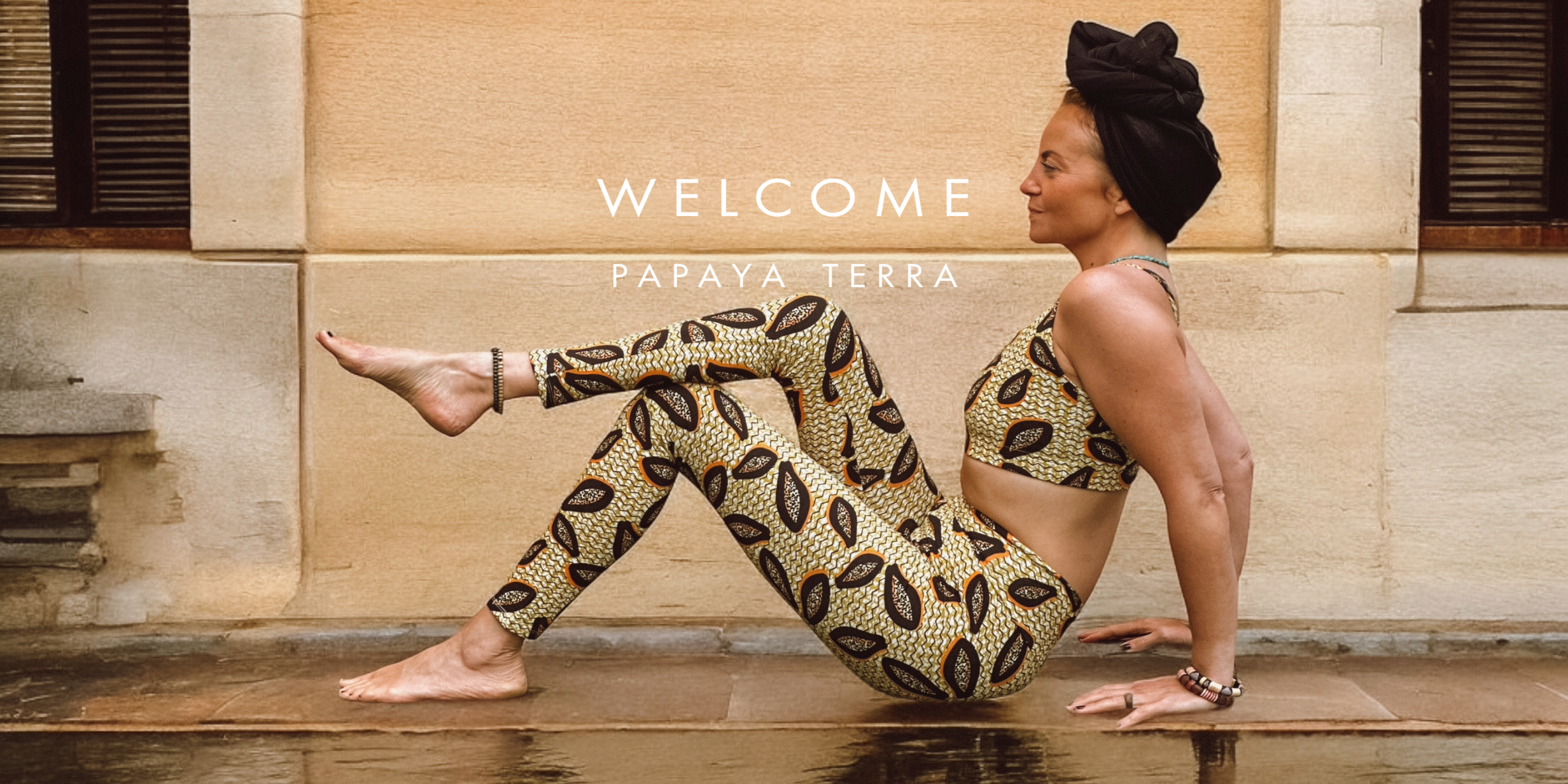 Woman in Papaya Terra leggings and bra. Colors black, orange and mustard yellow